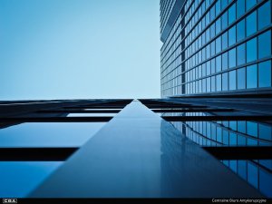 Photo of a glass building taken from the bottom.