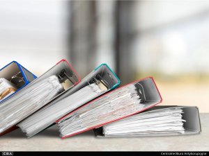 A photo of five binders laying on the table.