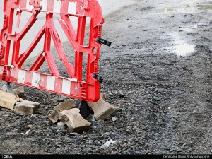 A road barrier standing on an unpaved road