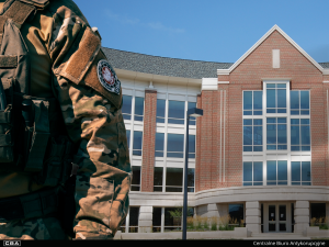 close-up of an officer, a building in the background