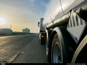 A tanker truck parked on a road in an industrial area
