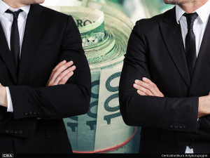 Two men in suits, with Polish banknotes in the background.