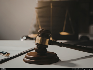 Judge's gavel, scales of justice in the background.